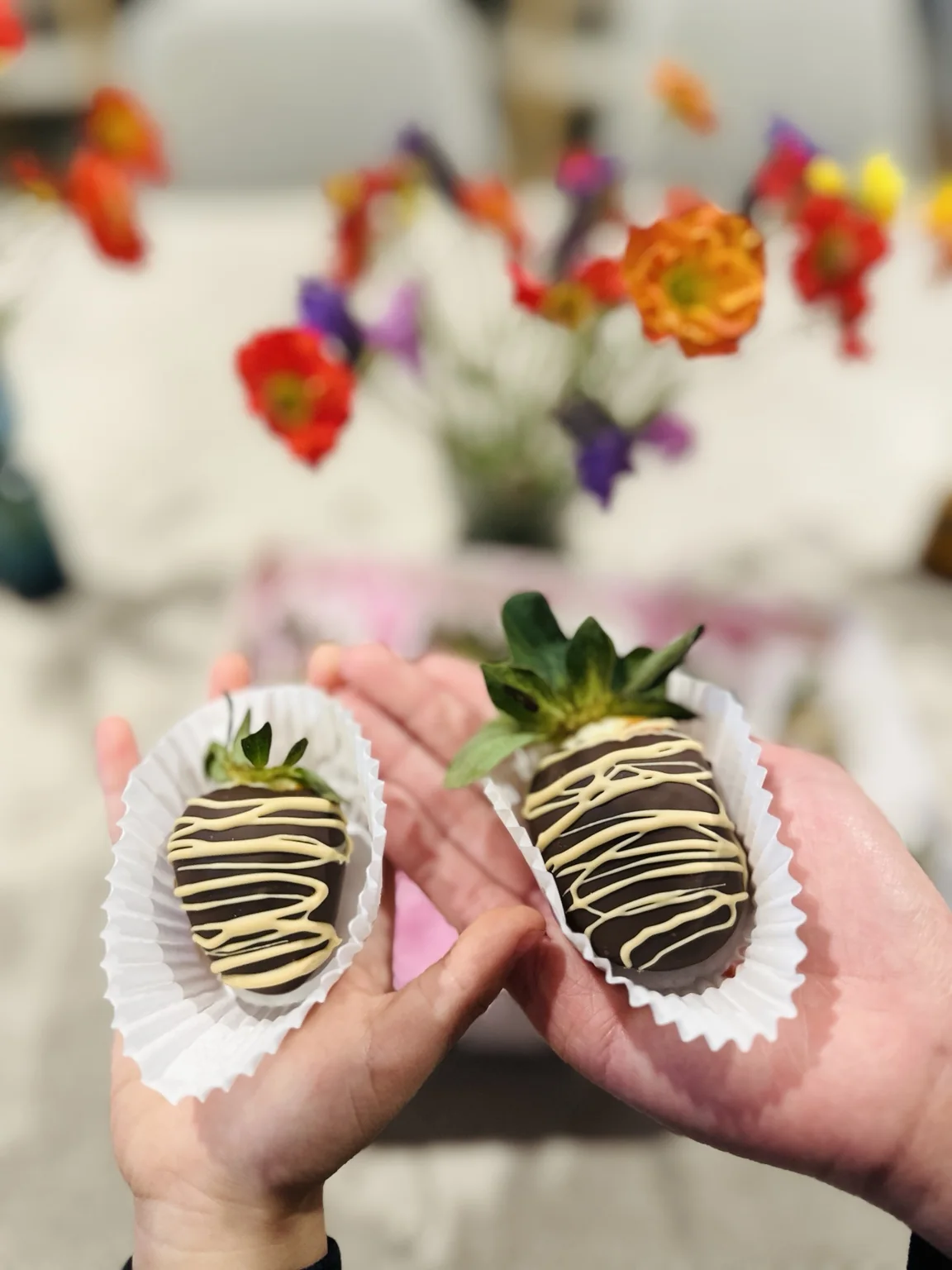 Chocolate-covered strawberries held ready to share