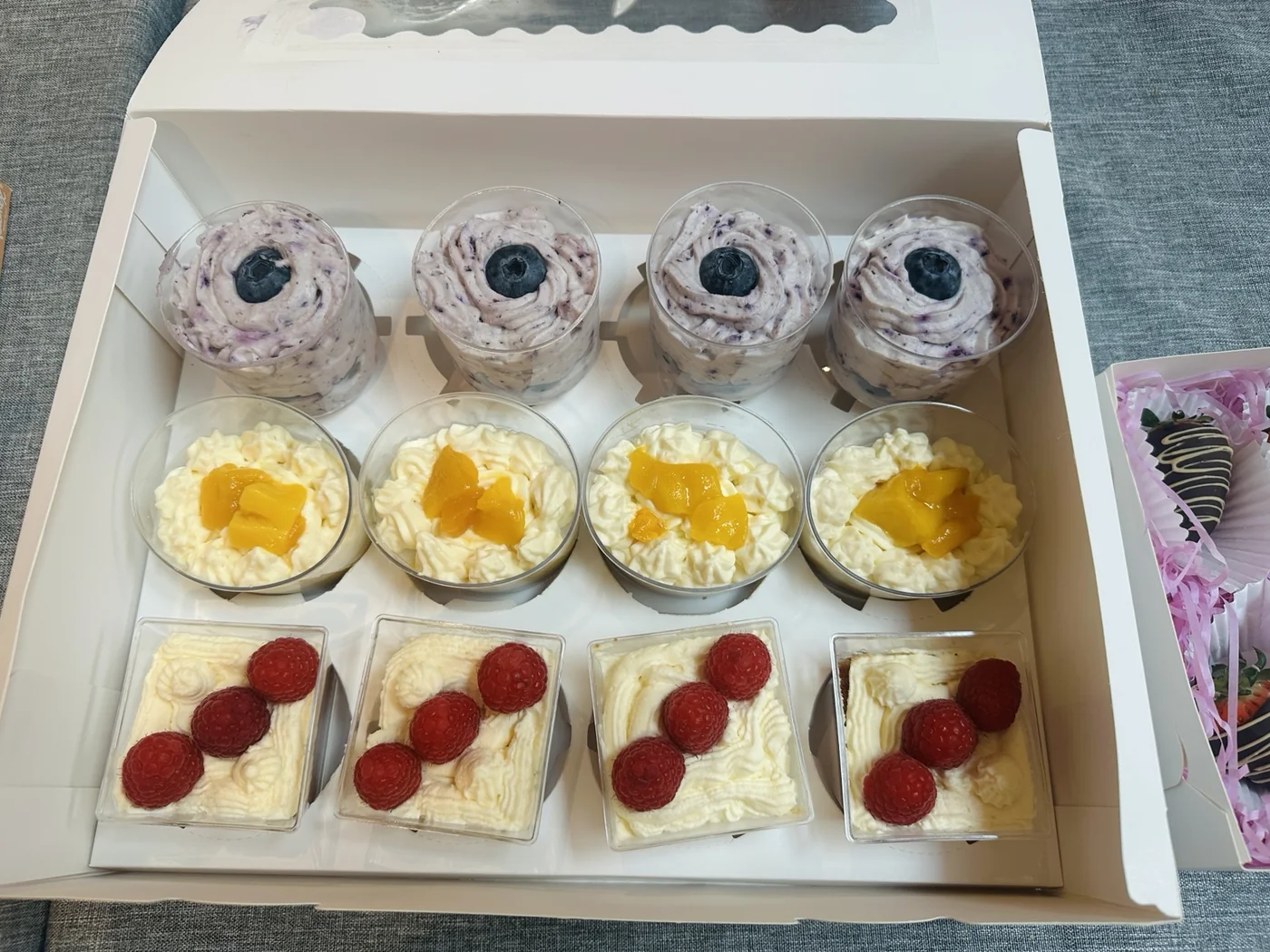 Mini desserts and fresh berries arranged together